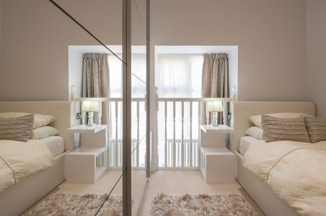 The single bedroom has a quirky window and balustrade.