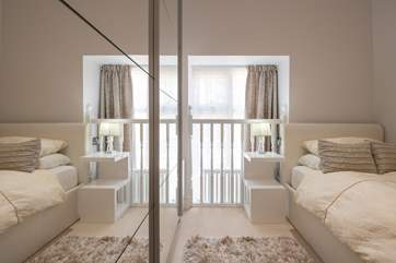 The single bedroom has a quirky window and balustrade.