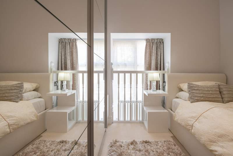 The single bedroom has a quirky window and balustrade.