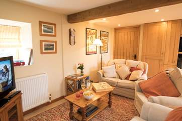 The cosy sitting-area is part of an open plan space, with a large kitchen and dining-area.