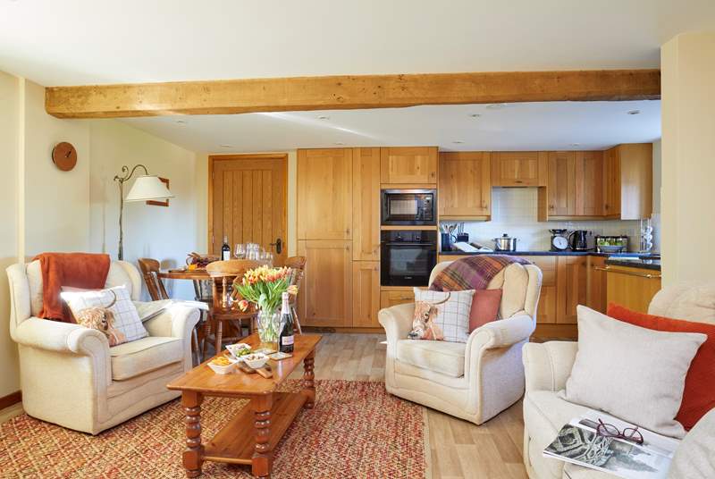 The cosy sitting-area is part of an open plan space, with a large kitchen and dining-area.