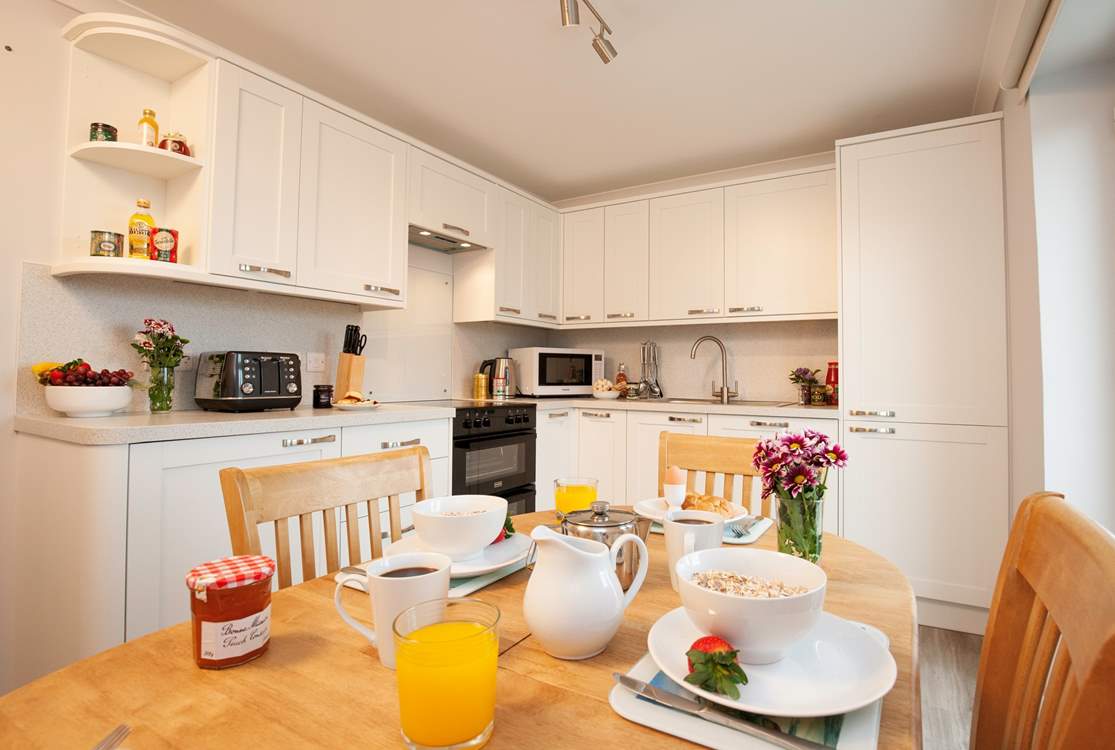 Enjoy family time together over meals in the modern kitchen and dining area.