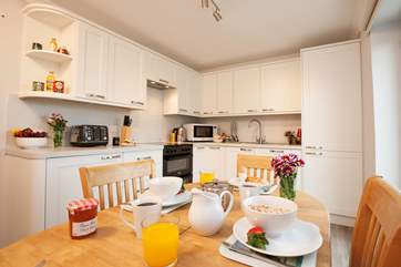 Enjoy family time together over meals in the modern kitchen and dining area.