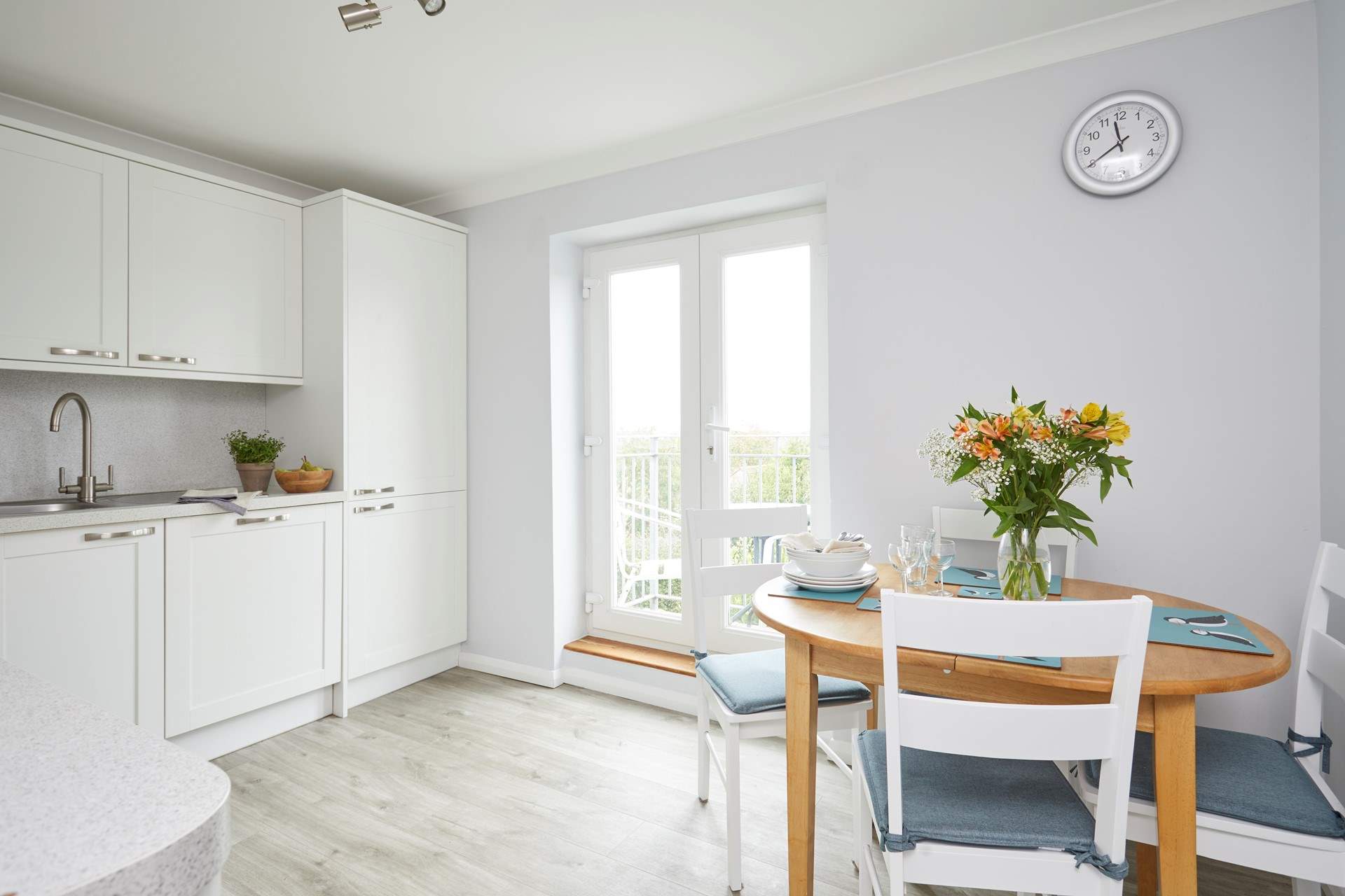 Double doors lead out to a second balcony and allow light to flood into the kitchen/dining area.