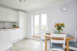 Double doors lead out to a second balcony and allow light to flood into the kitchen-dining area.