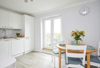 Double doors lead out to a second balcony and allow light to flood into the kitchen/dining area.