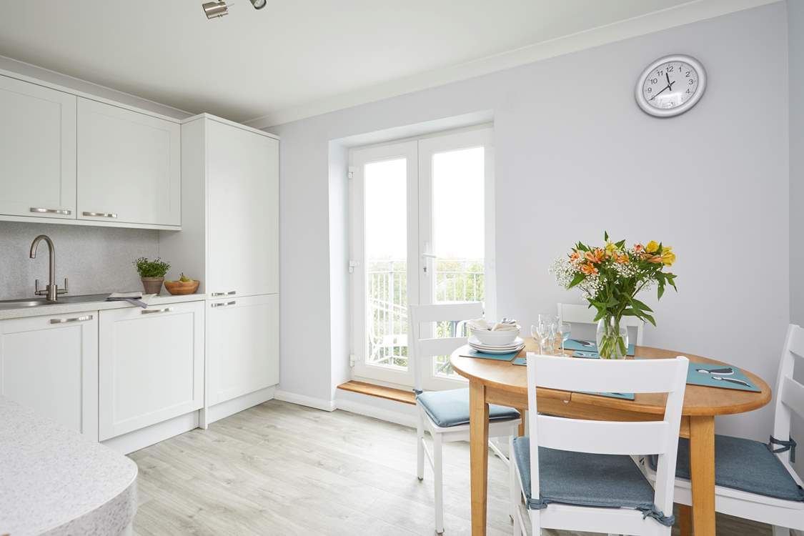 Double doors lead out to a second balcony and allow light to flood into the kitchen/dining area.