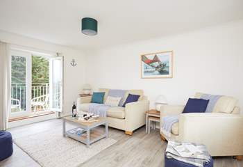 Double doors lead out to one of two balconies that overlook green, quiet countryside.