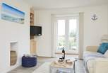 The inviting sitting room is cosy and full of natural light. 