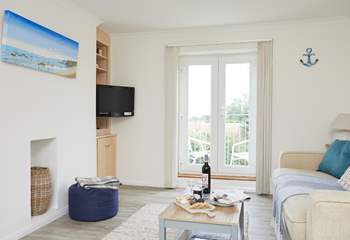 The inviting sitting-room is cosy and full of natural light. 