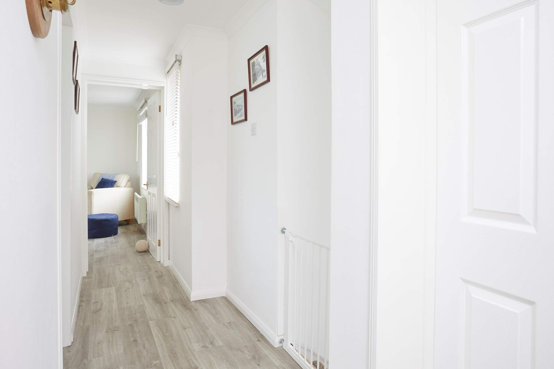 The lovely first floor hallway leads to each of the beautifully appointed rooms. 