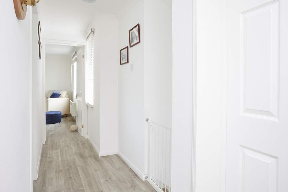 The lovely first floor hallway leads to each of the beautifully appointed rooms.