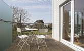 The sitting-room has a wrap-around balcony with a small table and chairs; the perfect place for a glass of vino whilst enjoying the views. - Thumbnail Image