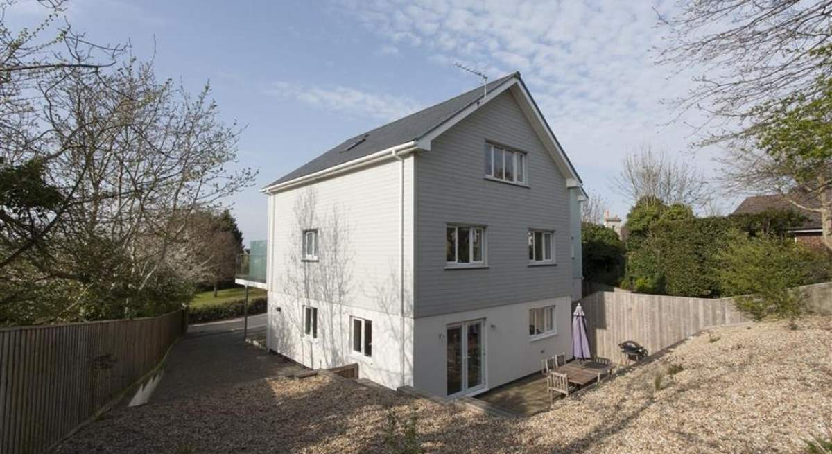 There is rear decking with garden furniture, enclosed by a raised shingle area (please note, the barbecue shown is no longer available for use).