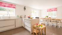 The contemporary kitchen/dining-room benefits from a breakfast-bar and is fully equipped.