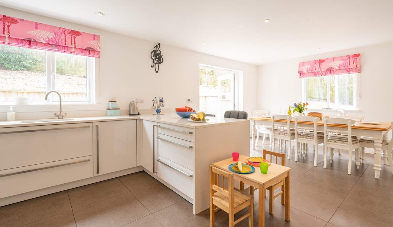 The contemporary kitchen/dining-room benefits from a breakfast-bar and is fully equipped.