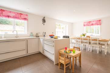 The contemporary kitchen/dining-room benefits from a breakfast-bar and is fully equipped.