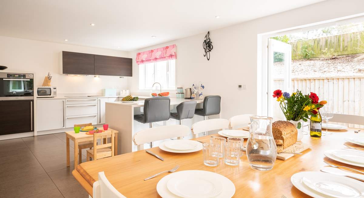 The beautiful kitchen/dining-room with doors opening onto the patio area.