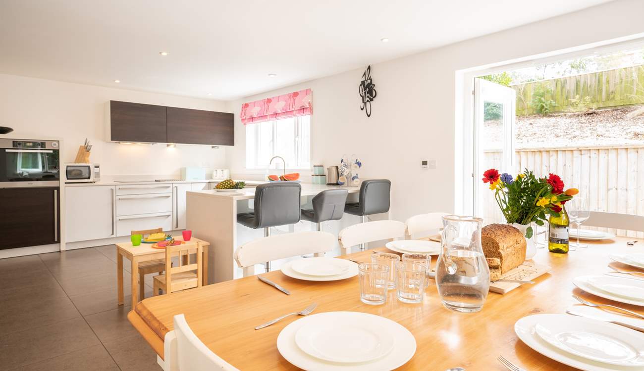 The beautiful kitchen/dining-room with doors opening onto the patio area.