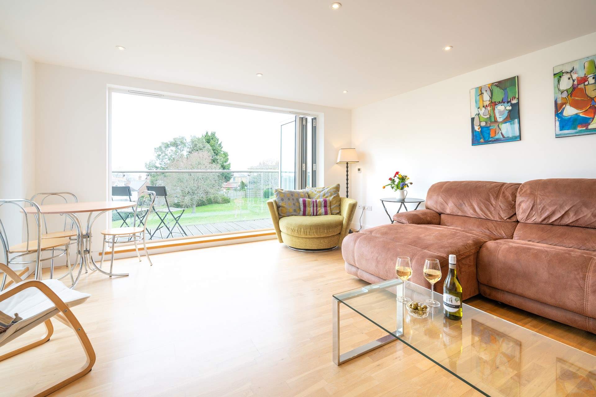 The spacious sitting-room, with generous seating, has doors leading to a large decked balcony.