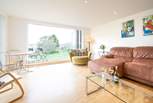 The spacious sitting-room, with generous seating, has doors leading to a large decked balcony.