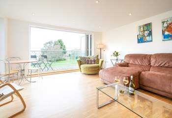 The spacious sitting-room, with generous seating, has doors leading to a large decked balcony.