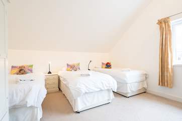 The fourth bedroom offers three single beds...