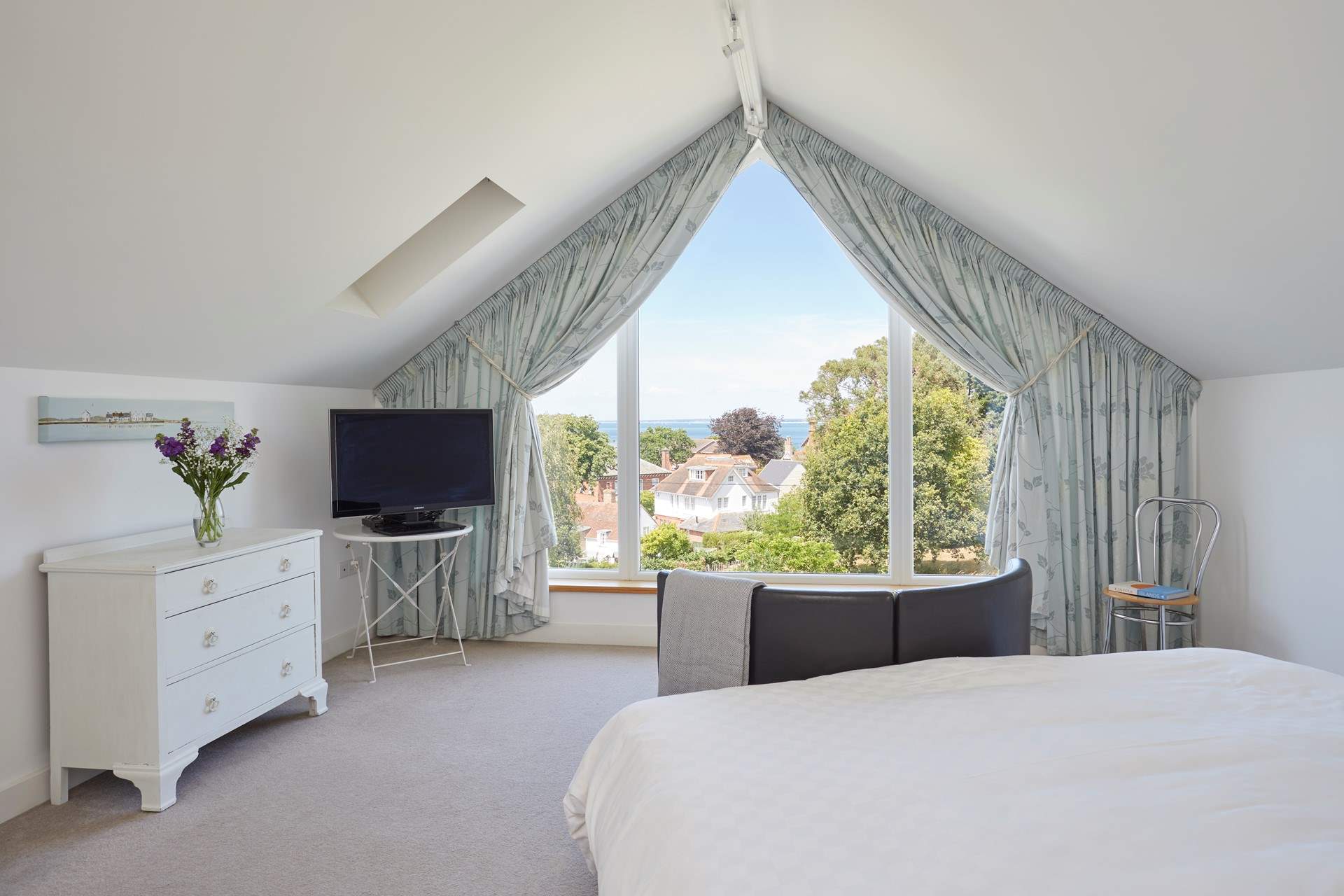 The main bedroom with sea views beyond the village rooftops.