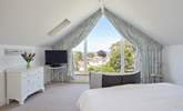 The main bedroom with sea views beyond the village rooftops. - Thumbnail Image