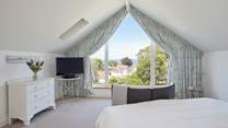 The main bedroom with sea views beyond the village rooftops.