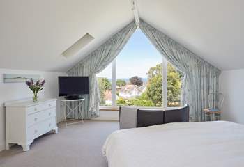 The main bedroom with sea views beyond the village rooftops.
