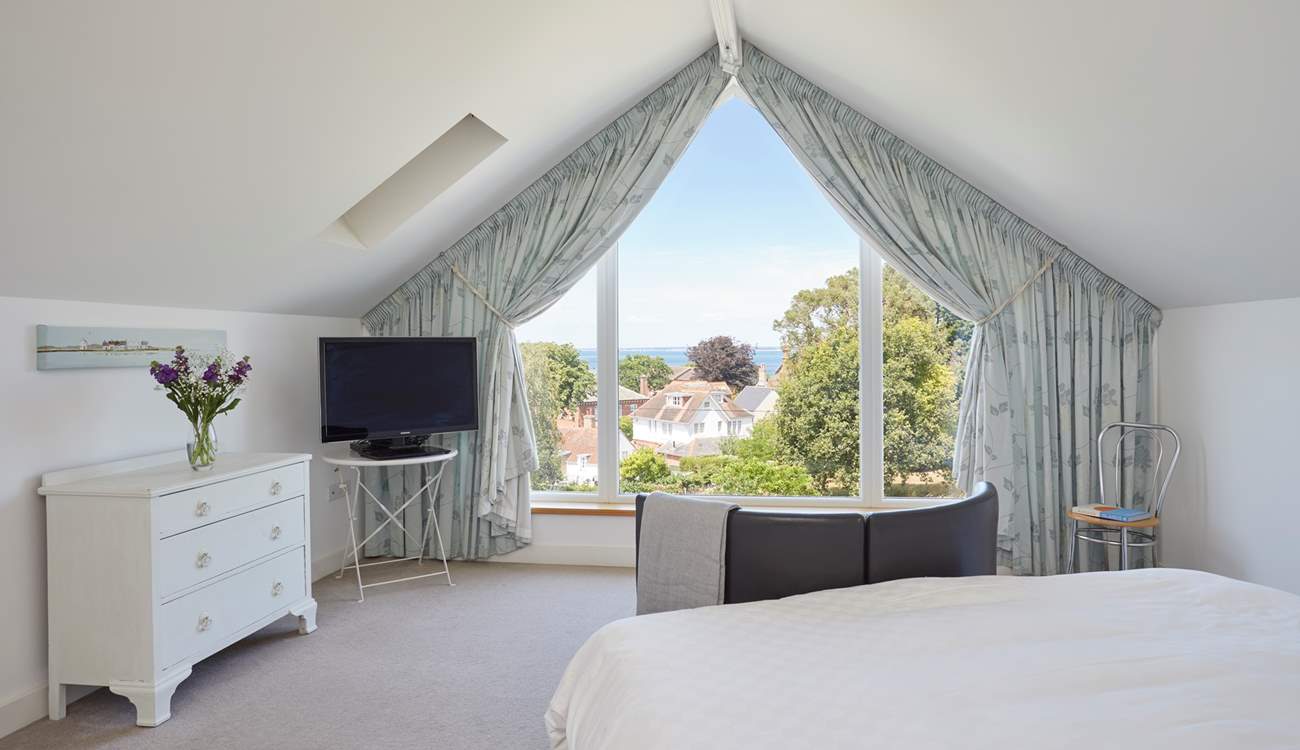 The main bedroom with sea views beyond the village rooftops.