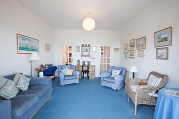 There is plenty of comfortable seating in the sitting-room, a cosy space for relaxing with a book, where you can raise your head and see the ships go by.