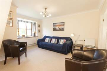 Bright and comfortable, the sitting-room leads on to a spacious kitchen/dining-room.