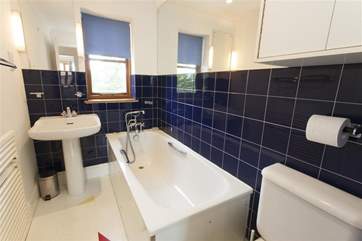 The bathroom on the ground floor offers a bath with hand shower attachment.