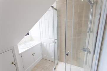 The master bedroom en suite shower-room is modern and light.