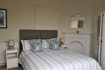 The first interconnecting bedroom with king-size bed and en suite shower-room.