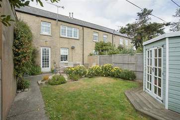 The front garden with seating for eight. Please note the summer-house has been removed.