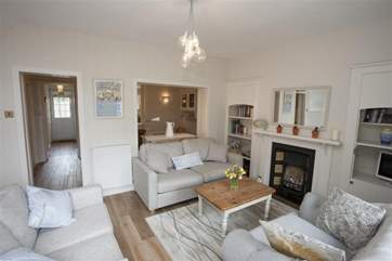 The sitting-room has very comfortable seating. The dining-room is behind.