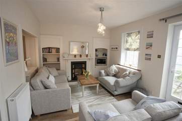 The sitting-room has direct access to the back garden.
