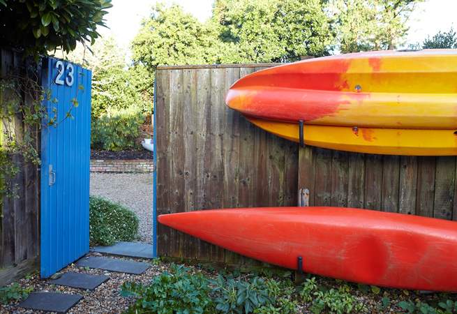 Kayaks stored along the fence to the garden at the front of the property. 