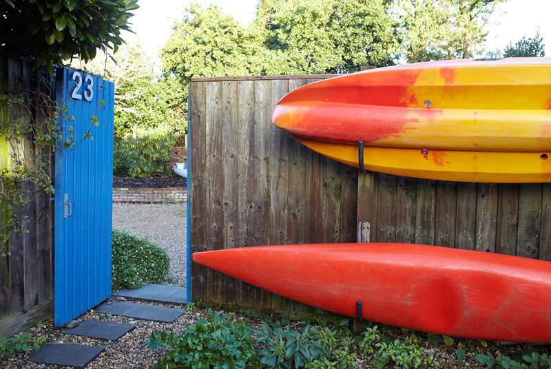 Kayaks stored along the fence to the garden at the front of the property. 