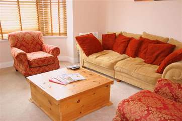 Soft furnishings make it a comfortable place to cuddle up to watch TV.