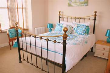The master bedroom has a king-size bed and plenty of space with the bay window.