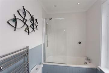 Nautical feel to the family bathroom, with a shower over the bath.