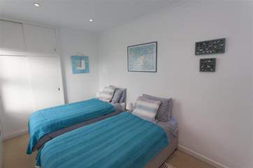 The twin bedroom is lovely and light, the colour scheme flows throughout the setting.