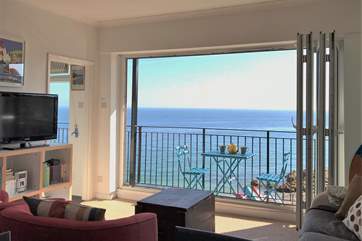 The bi-folding doors to the balcony, let the sea air and views spill into the living-room.