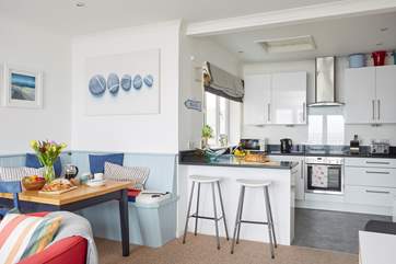 The open plan living space is light and bright with bi-fold doors to the balcony.