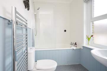 The family bathroom has a bath with shower over.