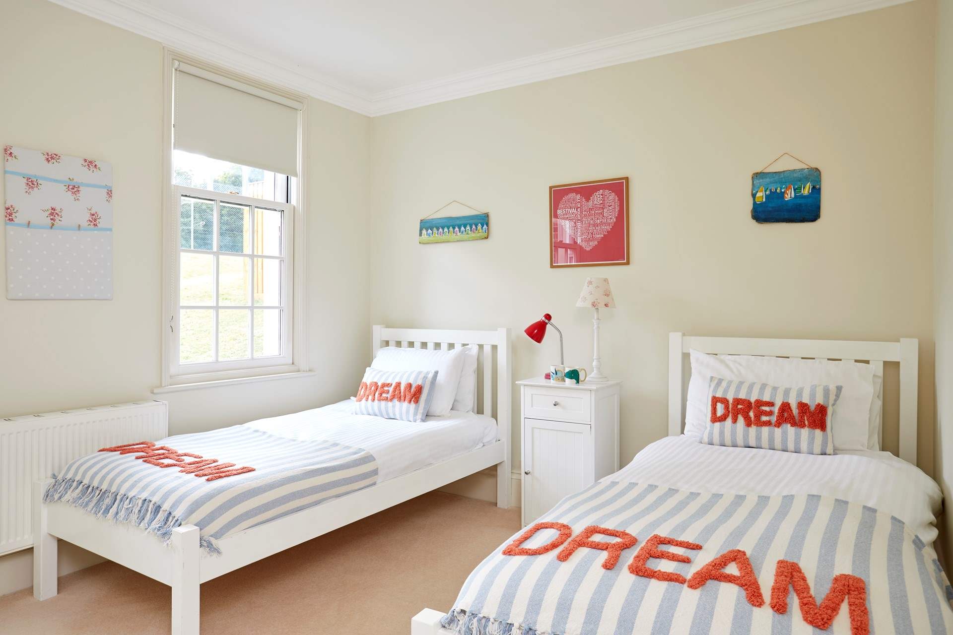 The bright twin bedroom overlooks the tennis court.